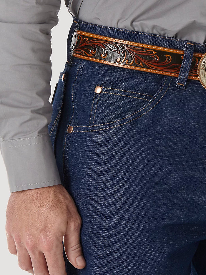 Closeup of front right scoop pocket of a man wearing Wrangler® Cowboy Cut®  relaxed fit rigid blue jeans with western shirt. Pocket has copper rivets on top corners and a coin pocket.