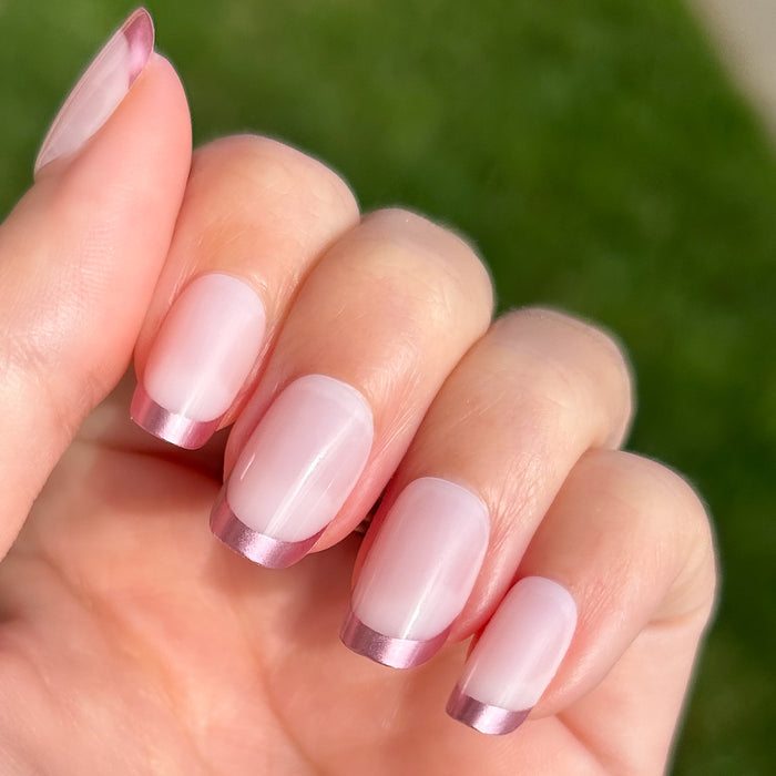 Metallic Matte French - Press-On | Short | Squoval with glossy metallic pink tips and smooth matte base on natural nails outdoors