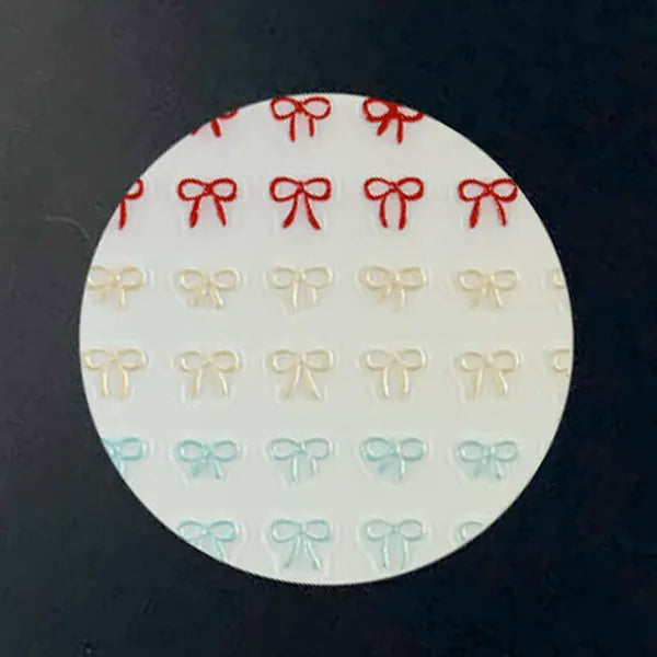 Mini Bows nail decal sheet with tiny bow outlines in rainbow rows