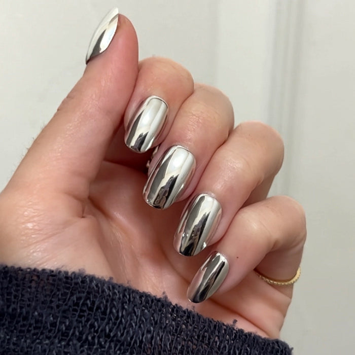 Hand with Mirror Chrome - Press-On | Short | Round nails showing reflective metallic silver press-on manicure close-up