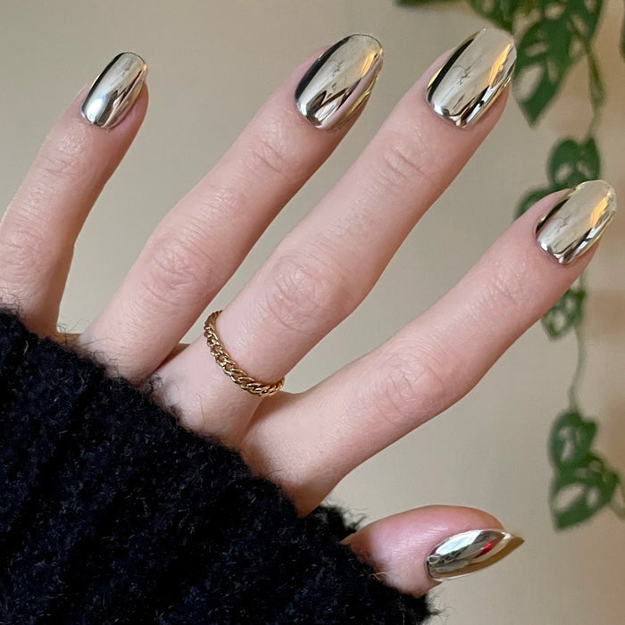 Mirror Chrome - Press-On | Short | Round shiny metallic silver press-on nails worn with gold chain ring on hand