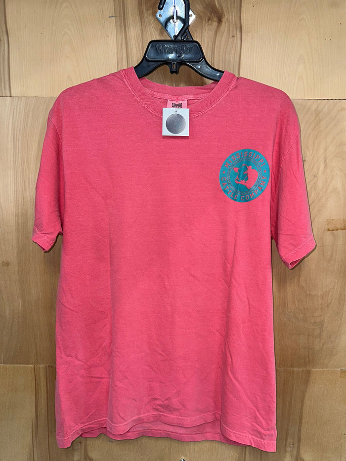 Mississippi Cattle Company Watermelon Short Sleeve Comfort Color T-Shirt wih teal circular Mississippi Cattle Company logo around cow head silk screened on left chest. Front view.