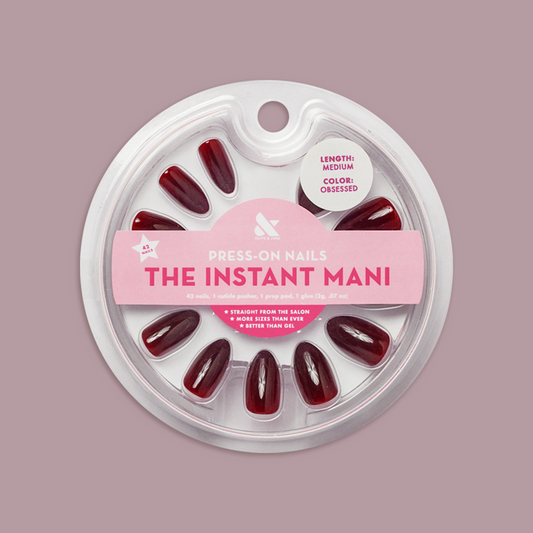 Obsessed - Press-On | Medium | Almond showing dark red medium almond false nails in clear circular package on mauve background