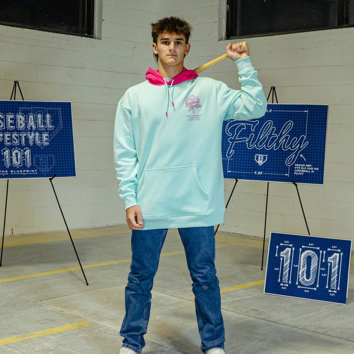 Person wearing light blue hoodie with pink hood and pink BL101 Ice cream logo