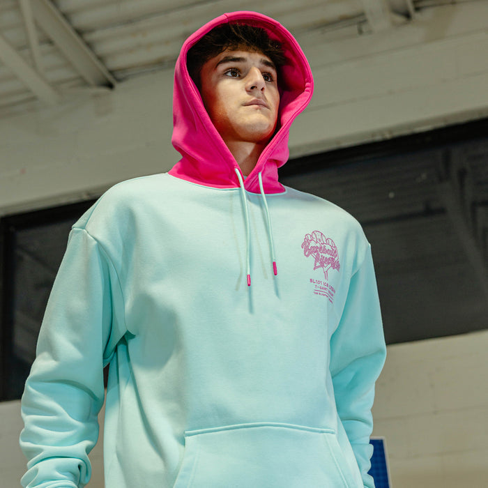 Person wearing light blue hoodie with pink hood and pink BL101 Ice cream logo