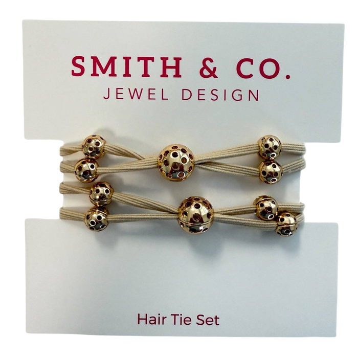Set of hair ties with gold beads on a 'Smith & Co. Jewel Design' card.