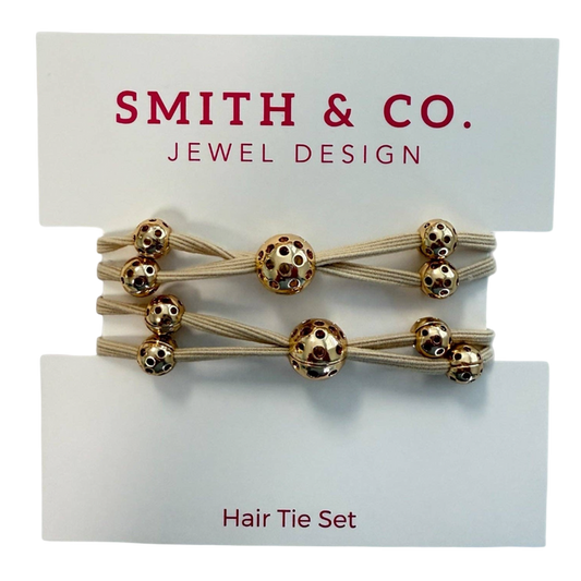 Set of hair ties with gold beads on a 'Smith & Co. Jewel Design' card.