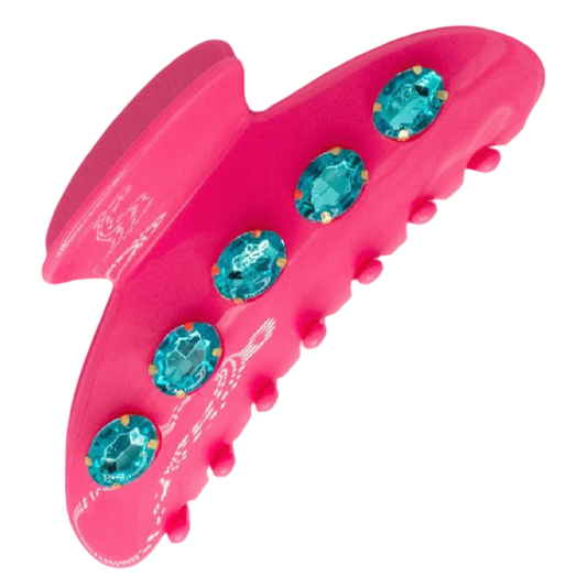 Pink hair clip with blue gemstones on a white background