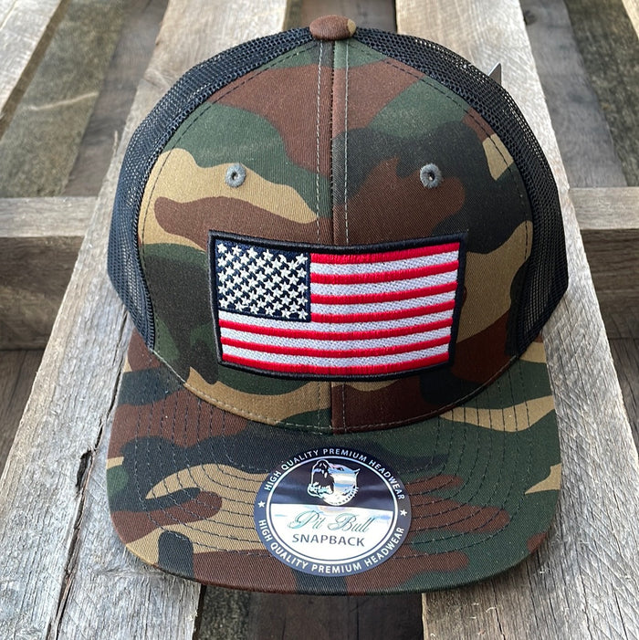 Camouflaged snapback cap with an embroidered American flag patch on the front and a Black mesh back. Front View