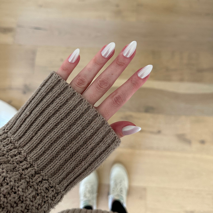 Purple Puka - Press-On | Medium | Almond showing iridescent lavender medium almond manicure on hand with neutral sweater sleeve