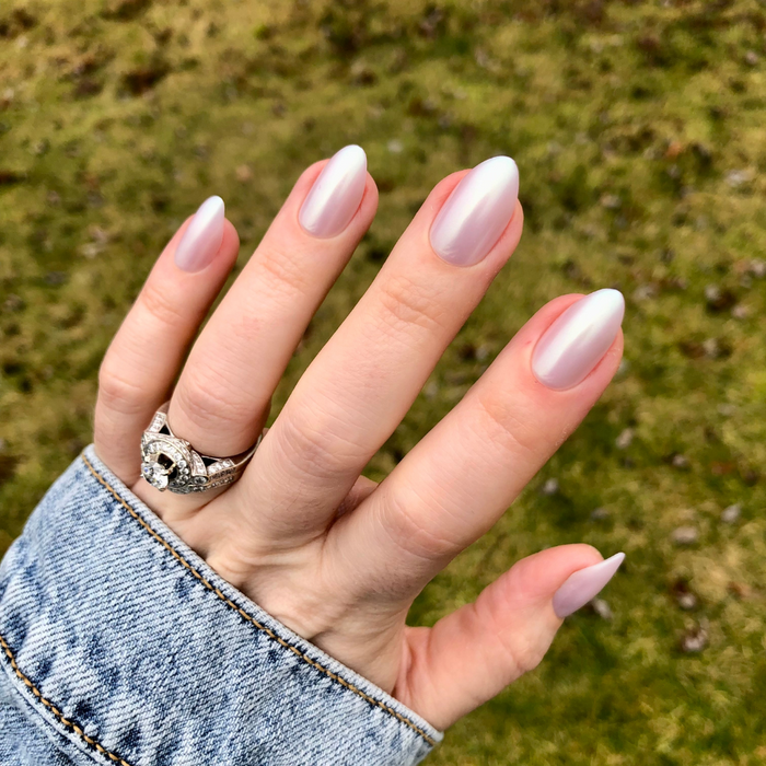 Purple Puka - Press-On | Medium | Almond showing iridescent lavender medium almond false nails on hand outdoors with denim sleeve