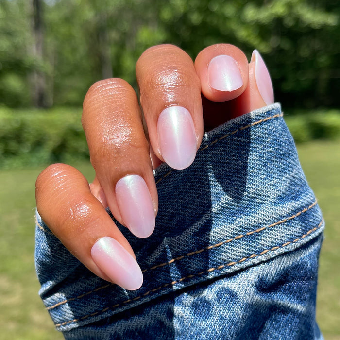 Purple Puka - Press-On | Medium | Oval showing iridescent lavender medium oval false nails on natural hand outdoors