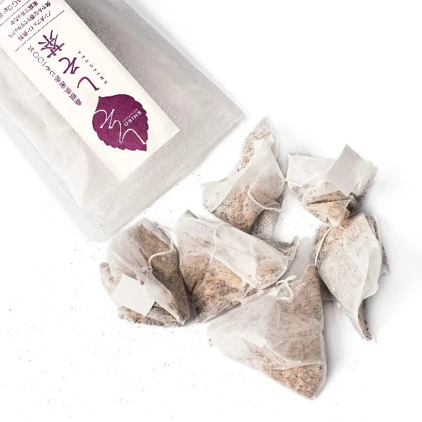 Tea bags in clear packaging with a branded box on a white background