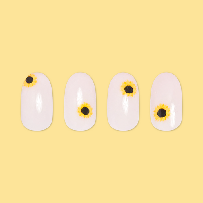 Scattered Sunflower - Press-On | Short | Round showing short round press-on nails with scattered sunflower designs on pale background