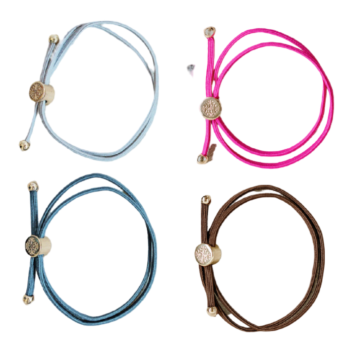 Four colorful bracelets with decorative ends on a white background