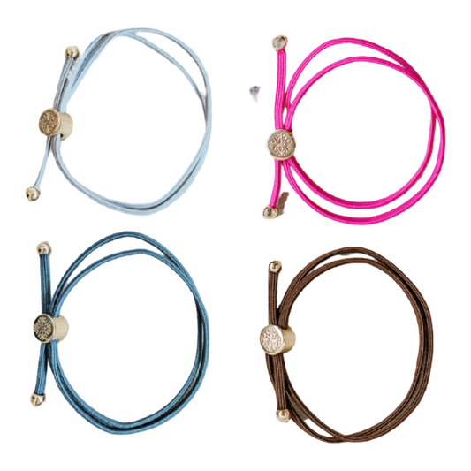 Four colorful bracelets with decorative ends on a white background