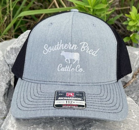 A Heather Grey Southern Bred 'O.G.' Cattle Co. Richardson 112PL R-Flex adjustable snapback cap with a white logo and a mesh back.