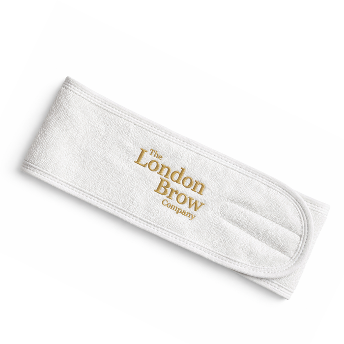White headband with 'The London Brow Company' logo on a white background