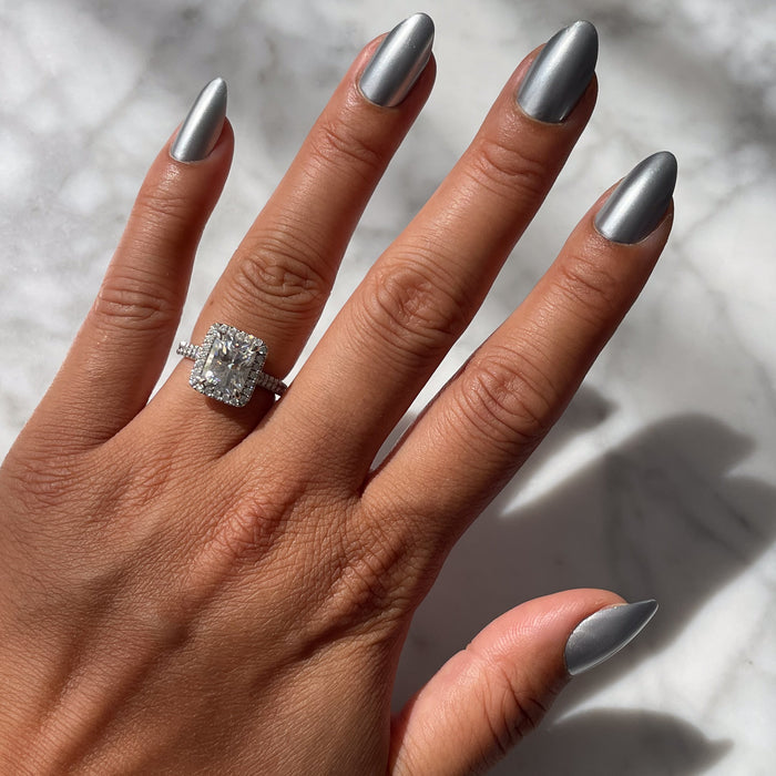 Hand with Steel Velvet - Press-On | Medium | Almond false nails in steely silver metallic finish under natural light on marble surface