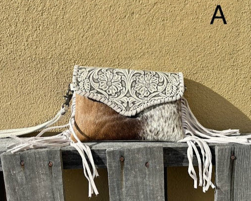 This Beige tooled leather bag can be used as a wristlet or shoulder bag with removable straps. It has side fringe and inside card slots. Front View A