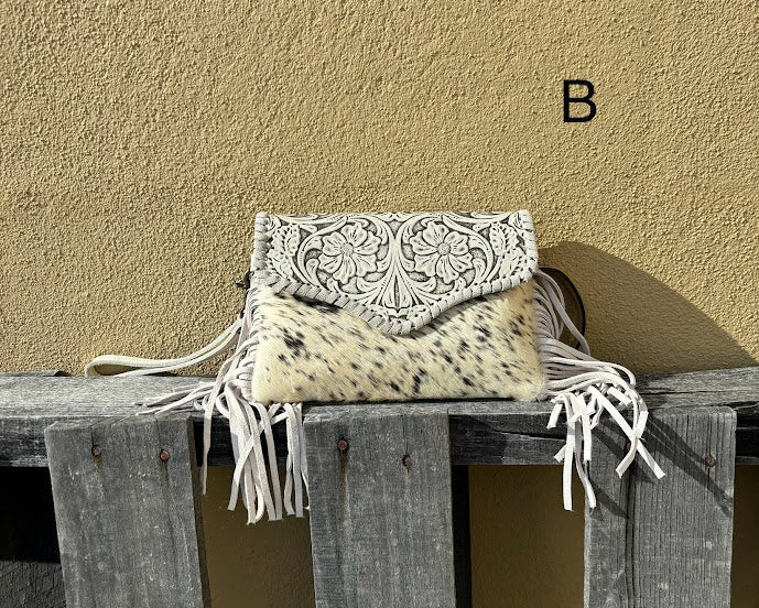 This Beige tooled leather bag can be used as a wristlet or shoulder bag with removable straps. It has side fringe and inside card slots. Front View B