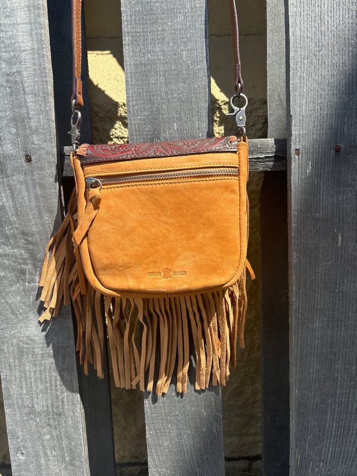 This Brown tooled leather and fringe crossbody bag has a removable and adjustable strap.  Rear view showing zippered closure on outside pocket.