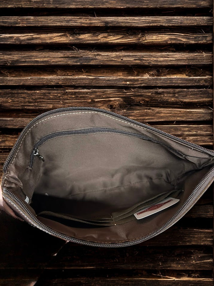 This Brown tooled leather and cowhide purse features a removable adjustable shoulder strap and a zippered closed concealed carry pocket on the rear. Inside it has six card slots and a zippered closed pocket. Inside View