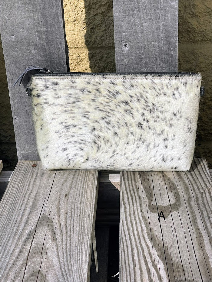 Black leather and cowhide wristlet bag that also comes with a removable adjustable crossbody strap. This is a larger wristlet with a inside zip close pocket and credit card slots. Front View A