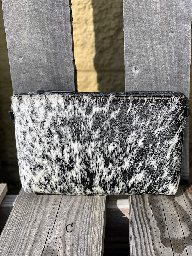 Black leather and cowhide wristlet bag that also comes with a removable adjustable crossbody strap. This is a larger wristlet with a inside zip close pocket and credit card slots. Front View C