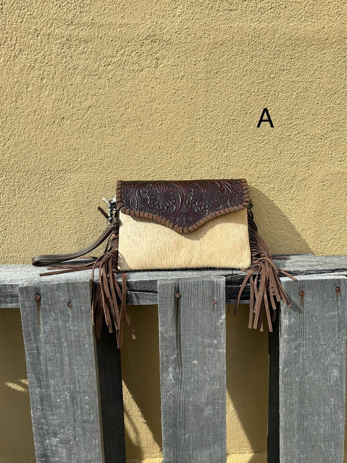 Cowhide and Coffee Brown tooled leather bag with side fringe. This bag features removable wristlet and shoulder straps. Front View A