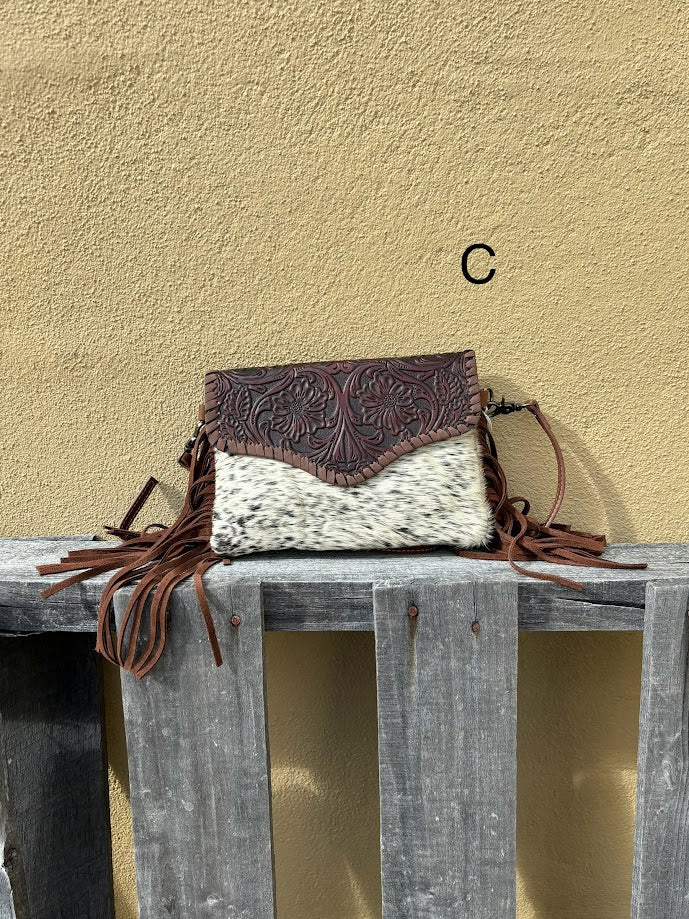 Cowhide and Coffee Brown tooled leather bag with side fringe. This bag features removable wristlet and shoulder straps. Front View C