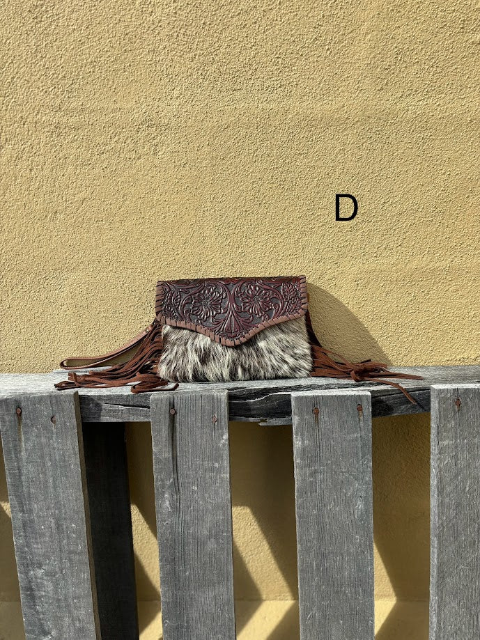 Cowhide and Coffee Brown tooled leather bag with side fringe. This bag features removable wristlet and shoulder straps. Front View D