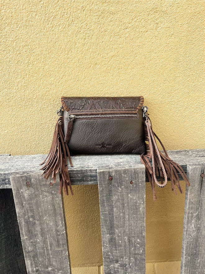 Cowhide and Coffee Brown tooled leather bag with side fringe. This bag features removable wristlet and shoulder straps. Rear view showing zippered pocket.