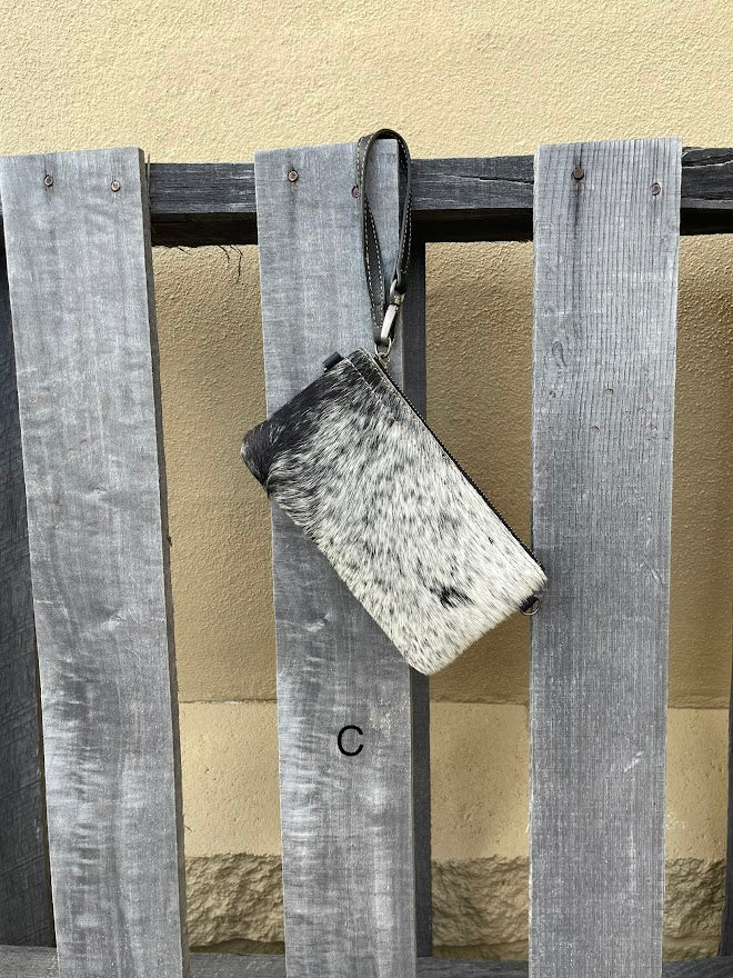 Cowhide wristlet purse in Black leather with a zippered closure. This bag has a wristlet handle or shoulder strap. Front View C