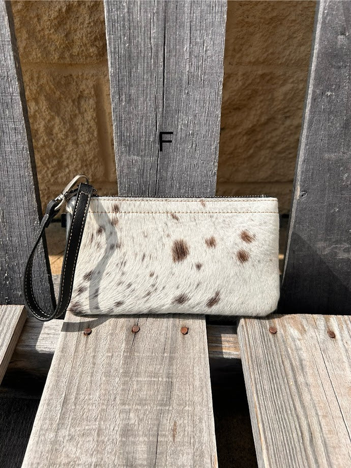 Cowhide wristlet purse in Black leather with a zippered closure. This bag has a wristlet handle or shoulder strap. Front View F