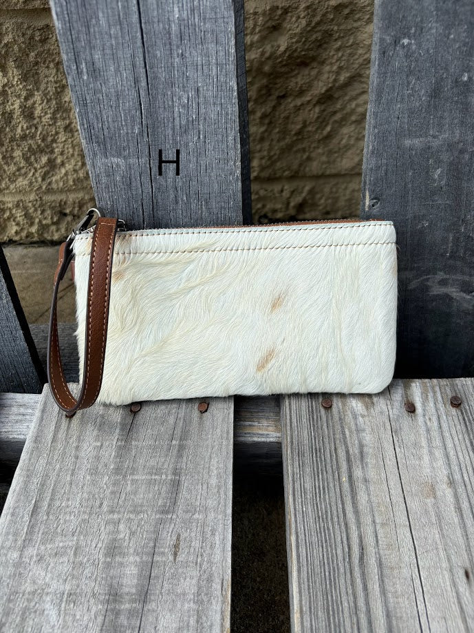 Cowhide wristlet purse with a solid Brown leather back and a zippered closure. It features a wristlet strap and and a adjustable removable shoulder strap. Front View H