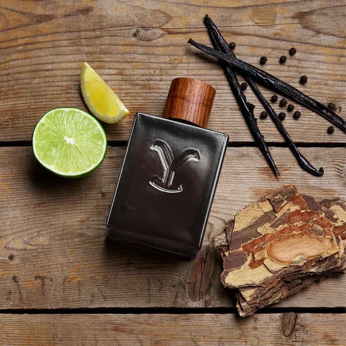Yellowstone Ride Reserve cologne bottle with representation of fragrance notes, Grapefruit, Black Pepper, and Cedar.