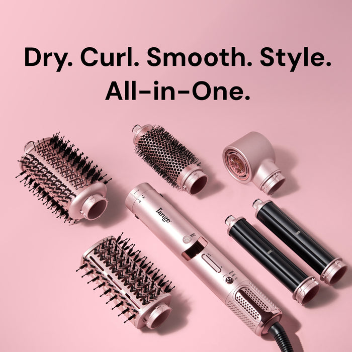 Flat lay of TurboStyle base and attachments on pink background. Text reads "Dry. Curl. Smooth. Style. All in One."