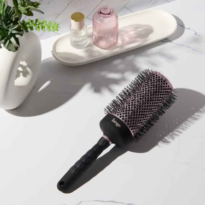Round brush on vanity.