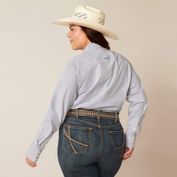 Women's Ariat long sleeve wrinkle resistant stretch shirt in True Blue. This Western style shirt is a blue and white pinstripe. Rear view showing shirt tucked in and blocked Ariat logo across yoke.