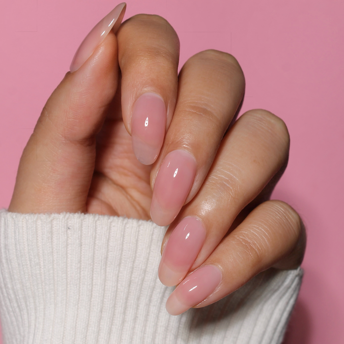 You Glow Girl milky pink nail polish manicure on a light skin tone with a white sweater